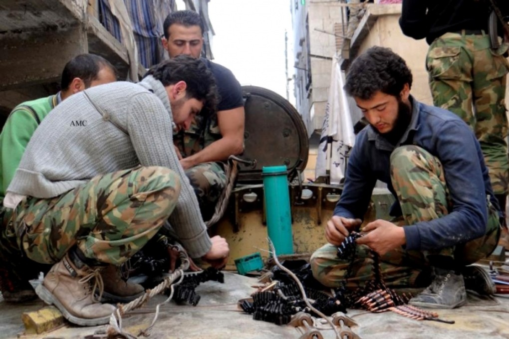 Members of the free Syrian Army preparing their weapons, in the neighborhood of al-Amerieh in Aleppo, Syria. Photo: AP