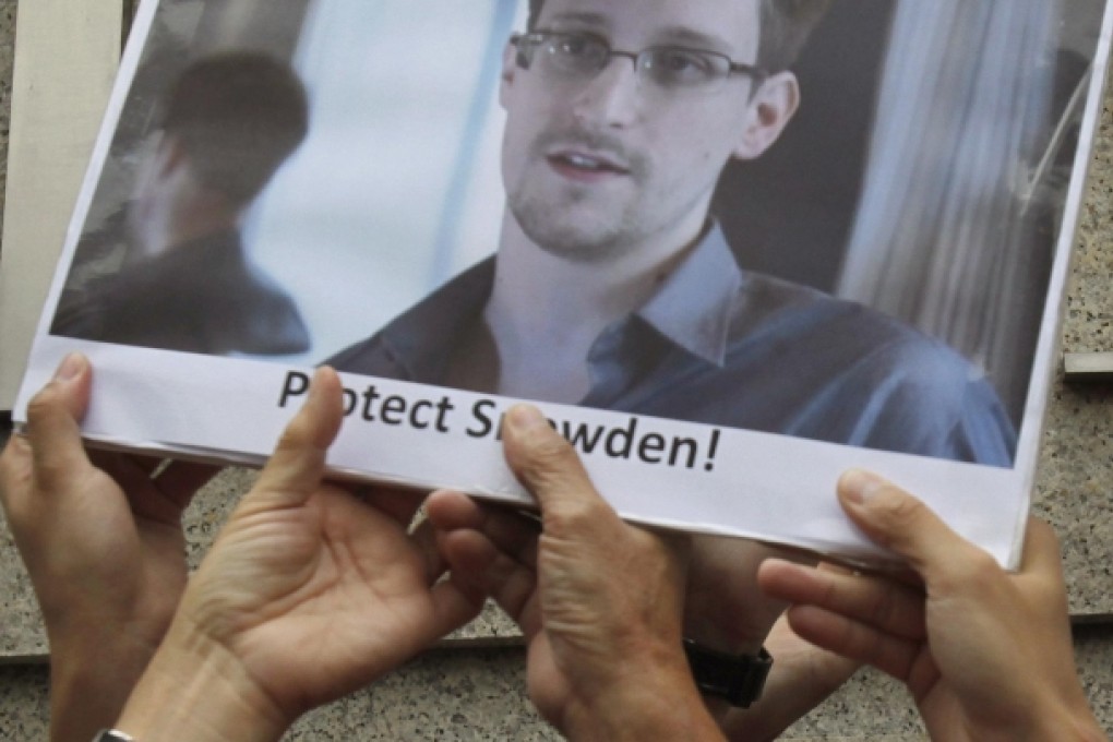 Protesters supporting Edward Snowden hold a photo of Snowden during a demonstration outside the US Consulate in Hong Kong. Photo: Reuters