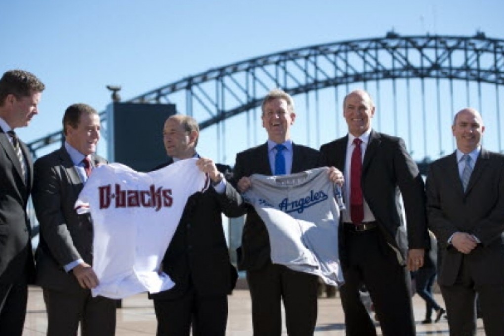 New South Wales state Premier Barry O'Farrell (3rd right) and Australia's Sports Minister Graham Annesley (2nd left) display baseball jerseys from the Arizona Diamondbacks (D-Backs) and Los Angeles Dodgers. Photo: AFP