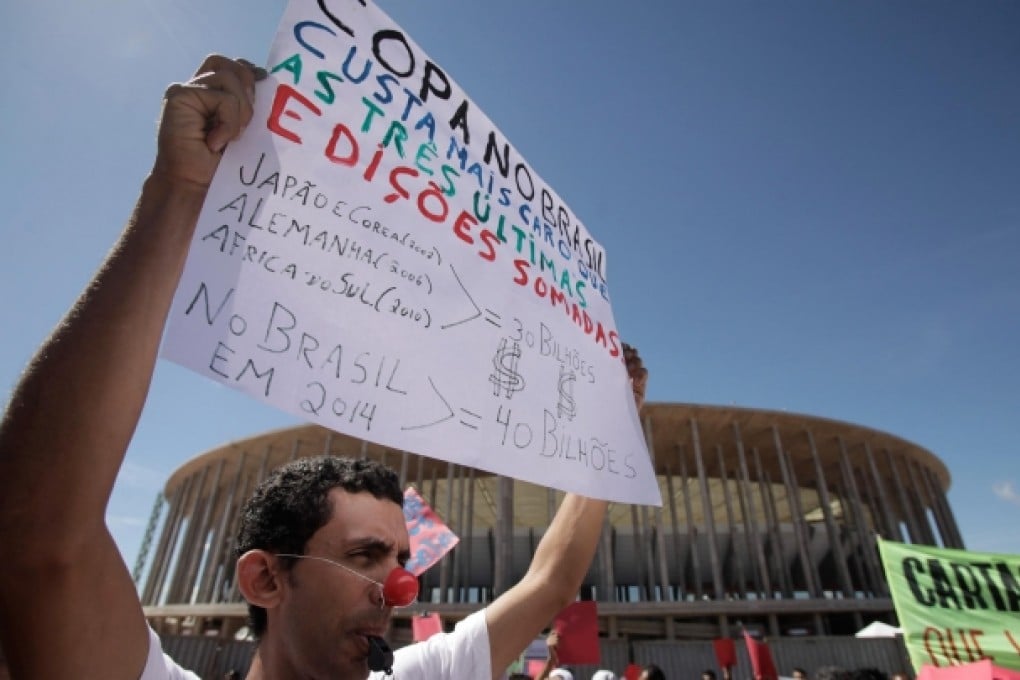 A protester's poster reads: 'World Cup in Brazil is more expensive than the last three editions.' Photo: AP