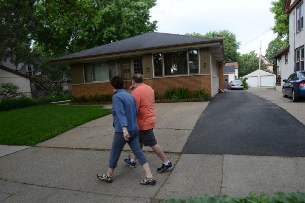 People walk past the home in Minneapolis, Minn., where 94-year-old Michael Karkoc lives. Photo: AP