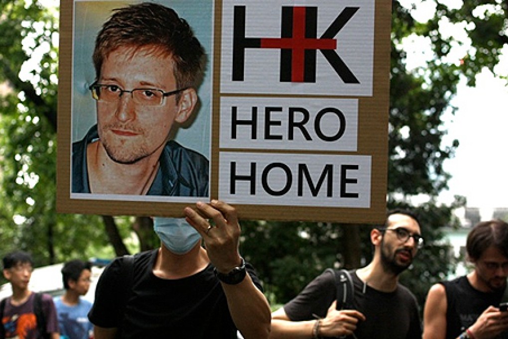 A protester holds up a photo of Edward Snowden during a march in support of him on June 15, 2013. Photo: Anja Klemensek