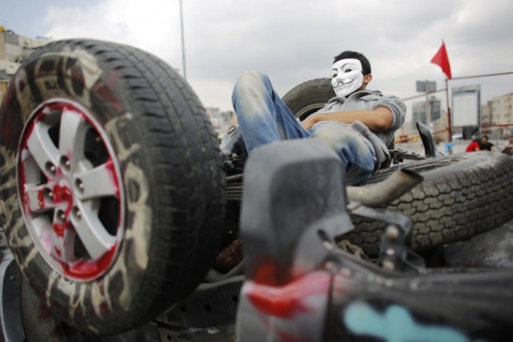 A protester on an overturned car in Gezi Park. Photo: Reuters