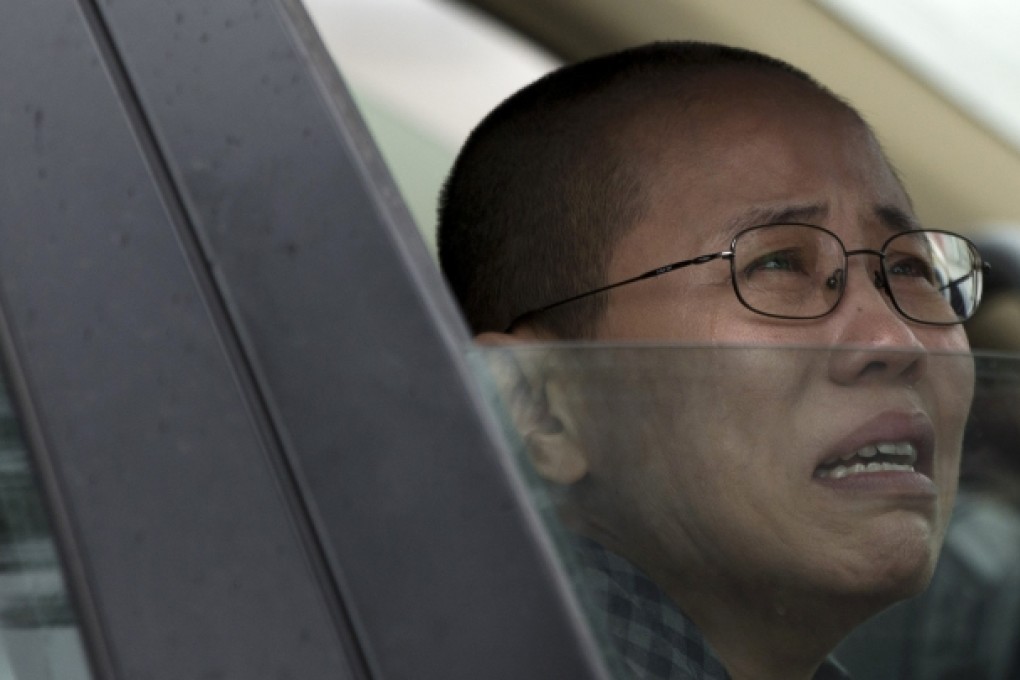 Liu Xia, wife of imprisoned Nobel Peace Prize winner Liu Xiaobo, weeps in anguish after her brother Liu Hui was jailed. Photo: AP