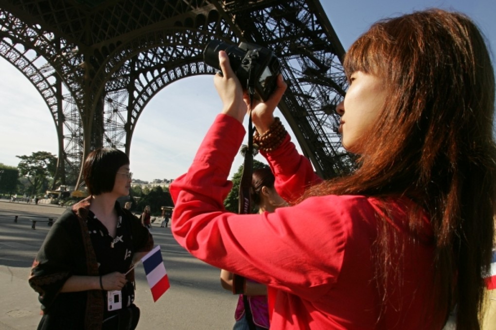 Chinese tourists visit the Eiffel Tower in Paris. Photo: AFP