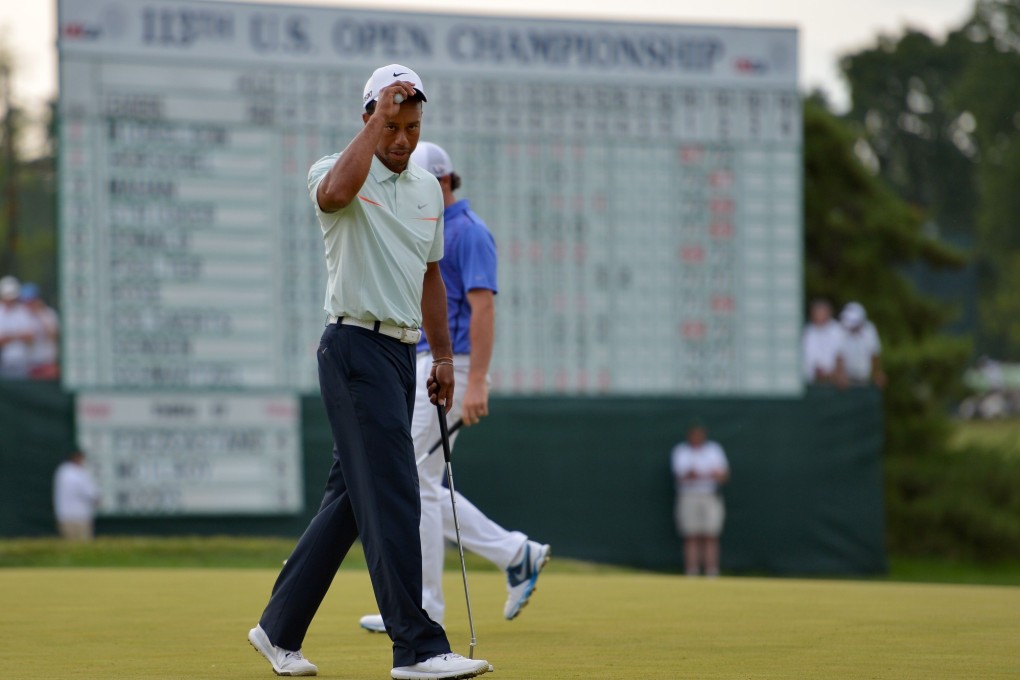 Tiger Woods of the United States tips his hat on the 18th hole during Round Three of the 113th U.S. Open at Merion Golf Club on Saturday in Ardmore, Pennsylvania. Photo: AFP