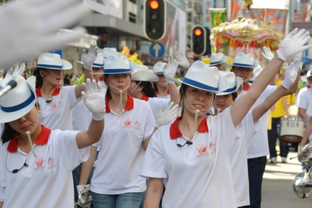 A band parades through the streets last year. Photo: Thomas Yau