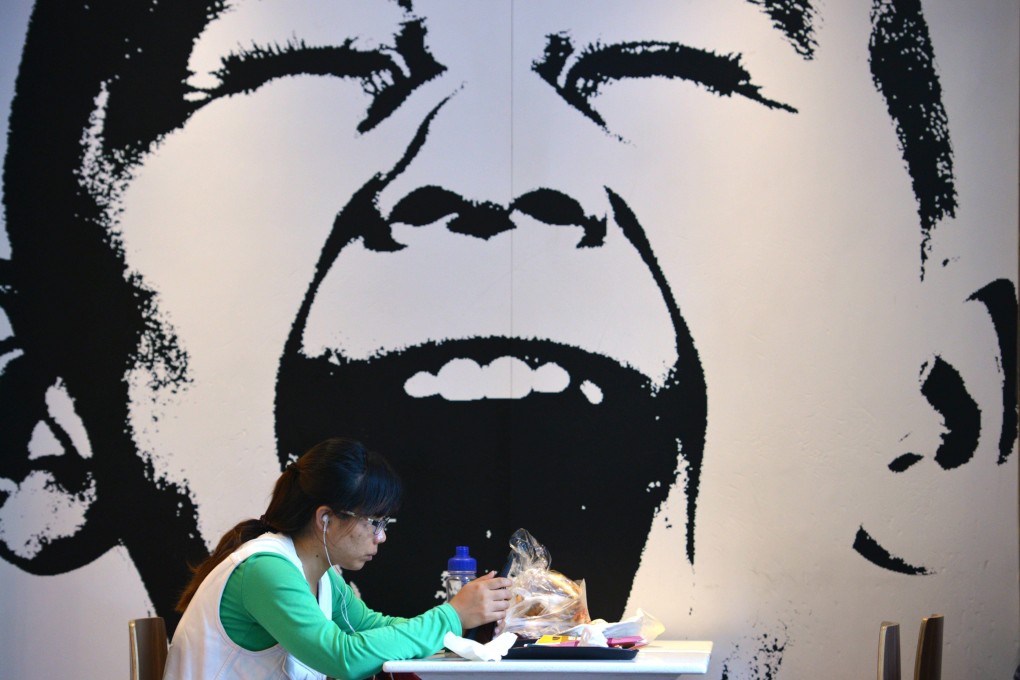 A woman eats at a fast food restaurant in Shanghai. Photo: AFP