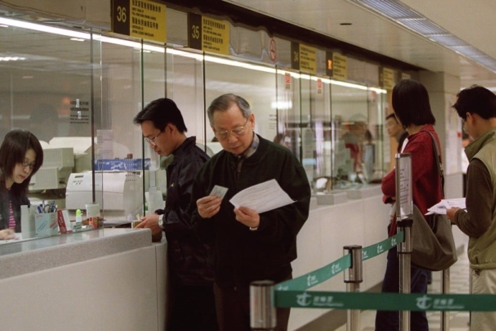 Drivers getting their licences at the Transport Department. More driving licences are issued under a scheme which allows non-local drivers to obtain a Hong Kong licence without a test than through the city's driving examinations. Photo: David Wong