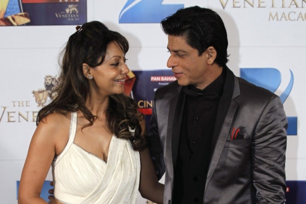 Indian Bollywood superstar Shah Rukh Khan poses with his wife, Gauri, on the red carpet of the Zee Cine Awards 2012 in Macau. Photo: AP