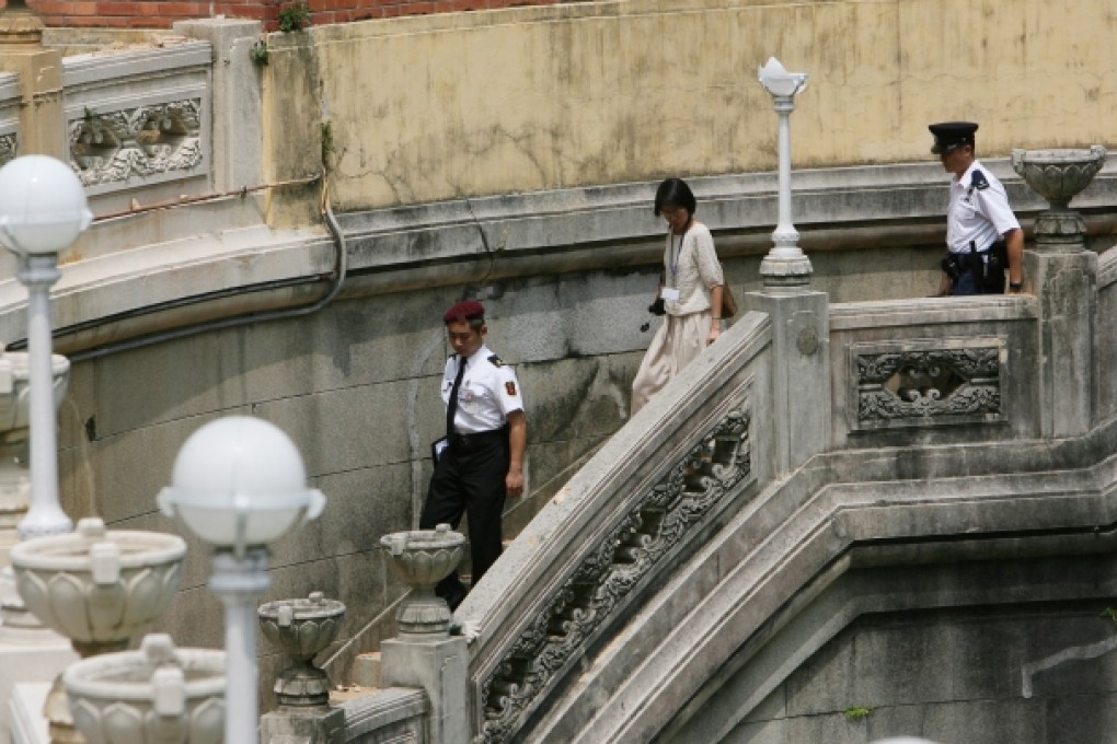 Officers from Antiques and Monuments Office (AMO) inspect and make notes of the latest condition of the mansion King Yin Lei, which was defaced when demolition work was carried out earlier on. Photo: Dustin Shum