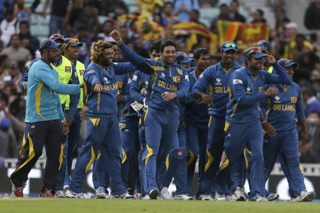Sri Lanka's Tilakaratne Dilshan (centre) celebrates with teammates after taking the wicket of Australia's Clint McKay caught and bowled to win their ICC Champions Trophy cricket match at the Oval cricket ground in London, on Monday. Photo: AP