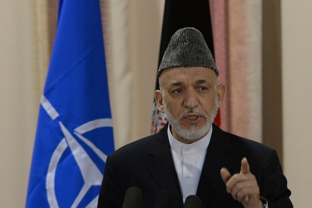 Afghan President Hamid Karzai speaks during a security handover ceremony at a military academy outside Kabul on Tuesday. Photo: AFP