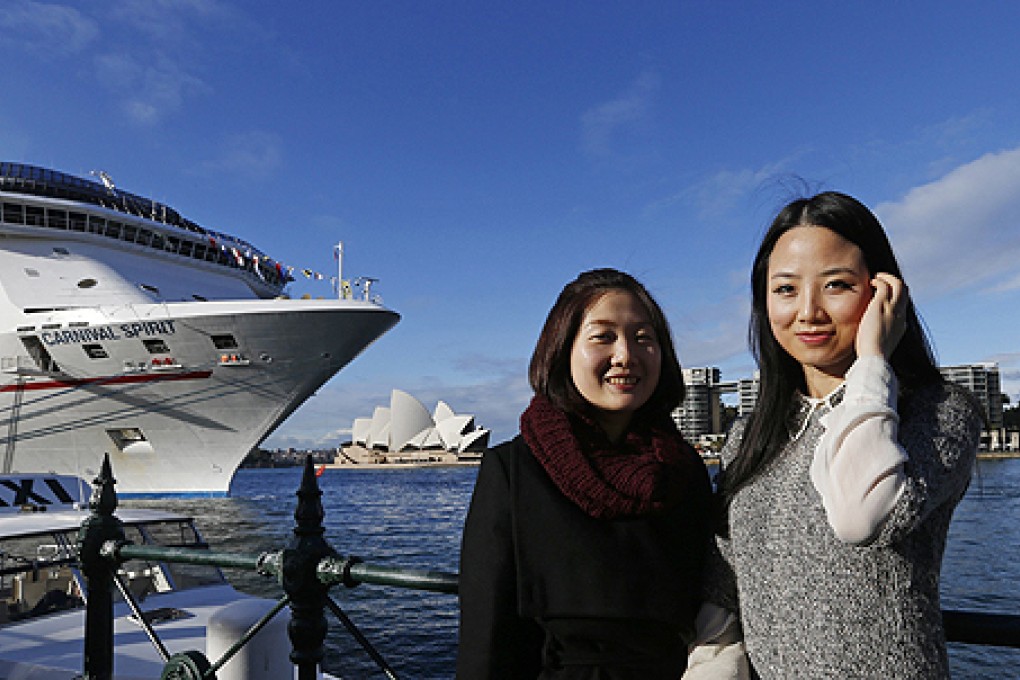 Chinese tourists Kelly Yang (right) and Amy Sheng pose for a picture in central Sydney. Photo: Reuters