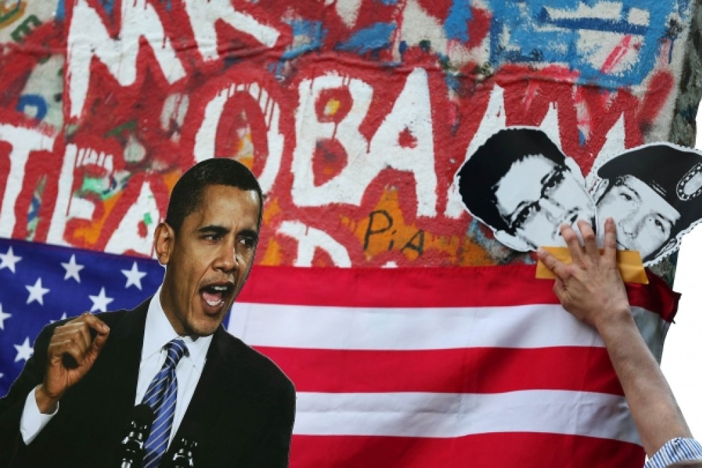 Activists display a photo of US President Barack Obama (left) and pictures of former US spy Edward Snowden (centre) and whistleblower Bradley Manning during a protest action in Berlin. Photo: AFP
