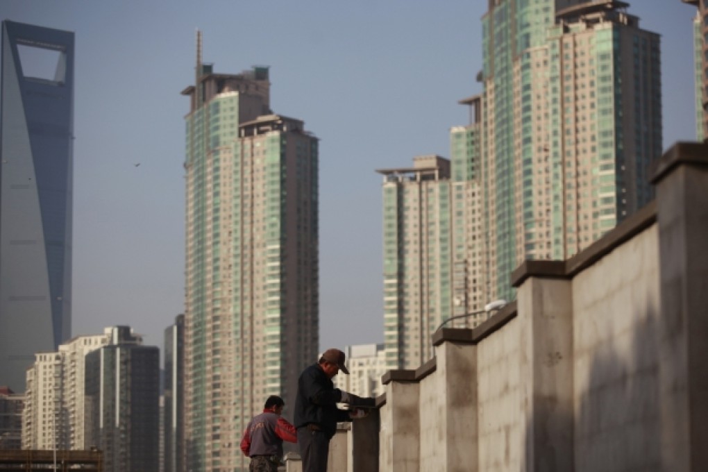 Workers build walls at a construction site at Pudong Lujiazui financial area in Shanghai. Photo: Reuters