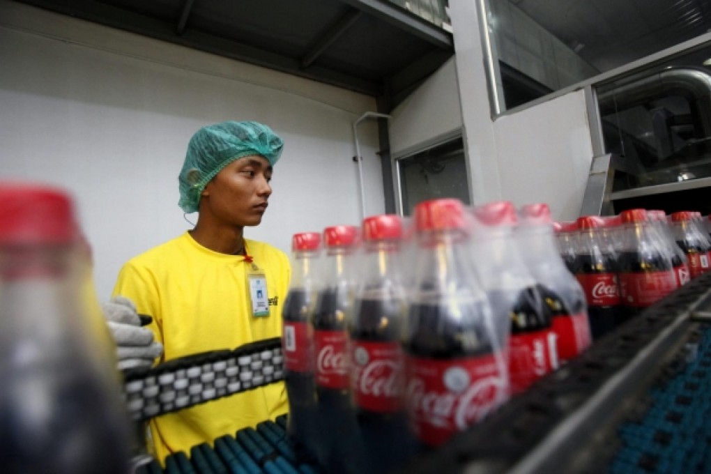 A worker at the Coca-Cola plant near Yangon. Photo: EPA