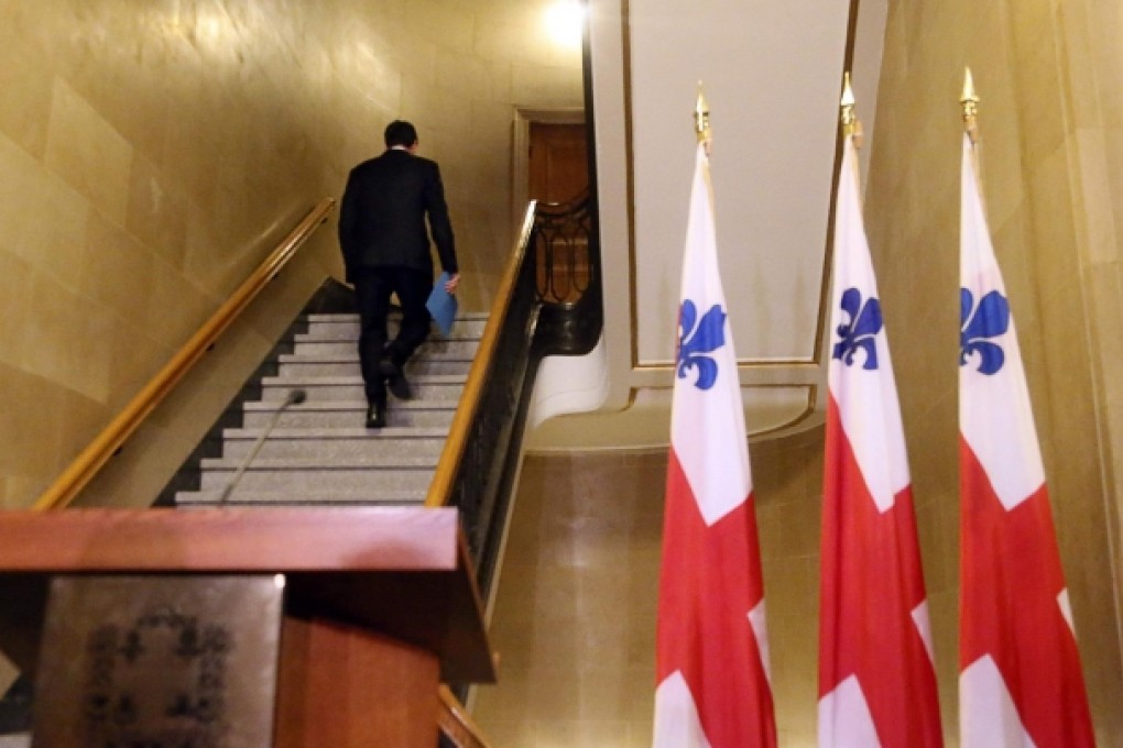 Montreal mayor Michael Applebaum walks away after announcing his resignation at a news conference in Montreal. Photo: Reuters