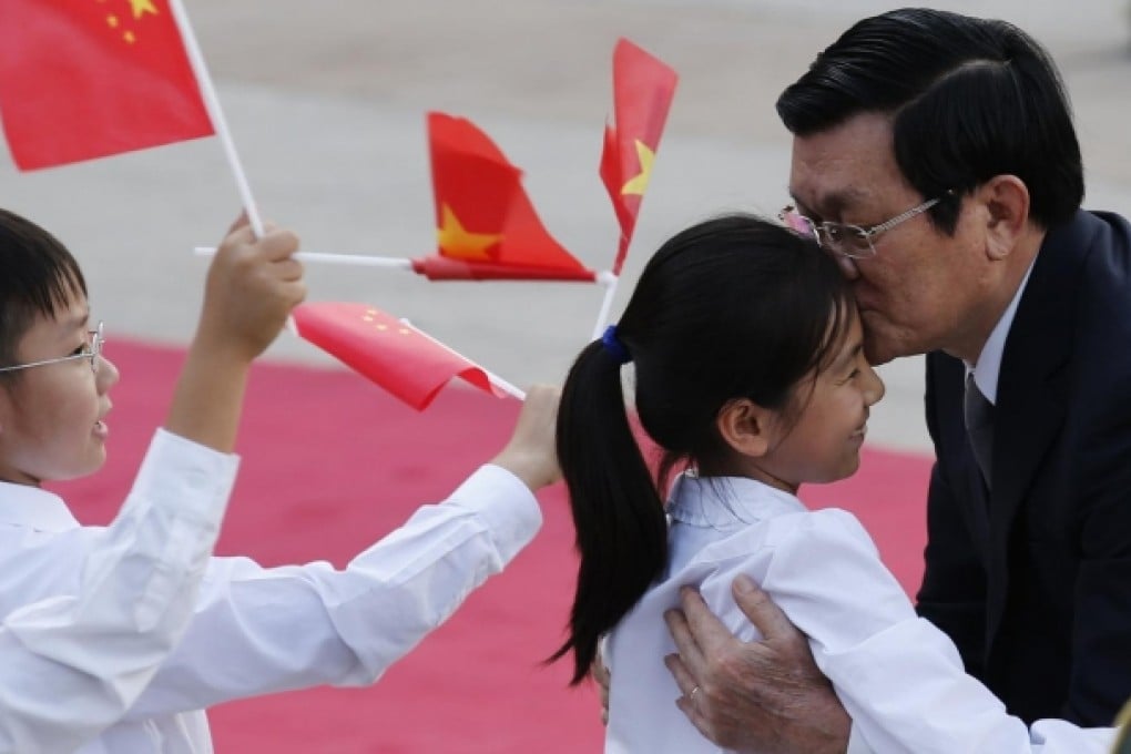 President Truong Tan Sang kisses a girl during a welcoming ceremony hosted by President Xi Jinping. Photo: Reuters