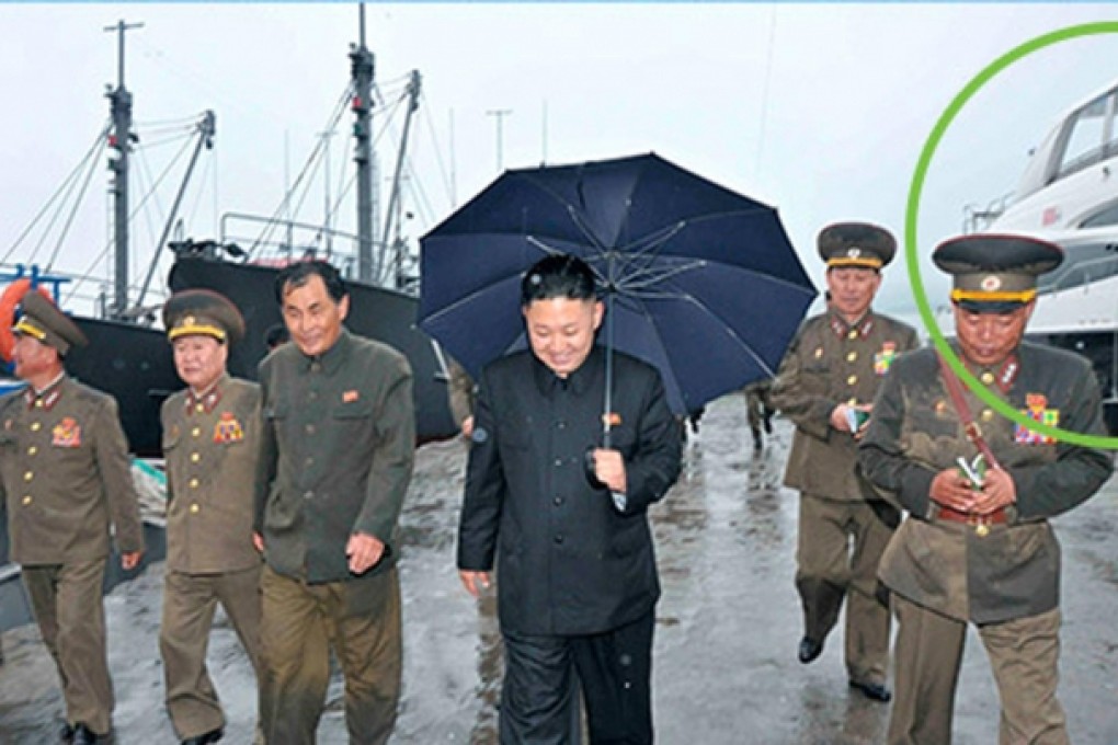 This KCNA photo shows Kim Jong-un inspecting the fishery station at Wonsan on North Korea's east coast last month. The luxury yacht, circled in green by NK News, is seen in the background.