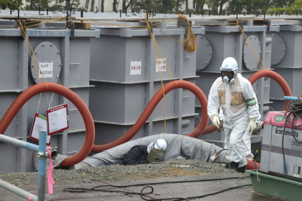A  worker walks in front of water tanks at Tokyo Electric Power Company's (Tepco) tsunami-crippled Fukushima Daiichi nuclear power plant in Fukushima prefecture. Photo: AFP