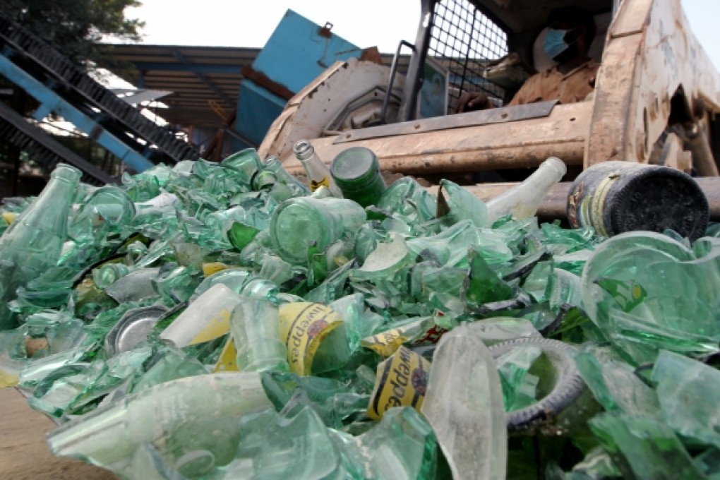 Piles of glass bottles are seen at Laputa glass recycling plant in Tuen Mun. The bottles will be recycled as bricks. Photo: Felix Wong