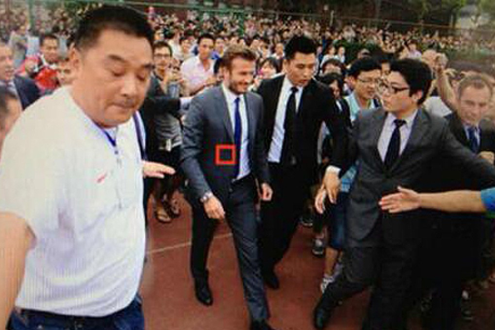 David Beckham (centre) enters Tongji University football stadium on Wednesday. Photo: Weibo