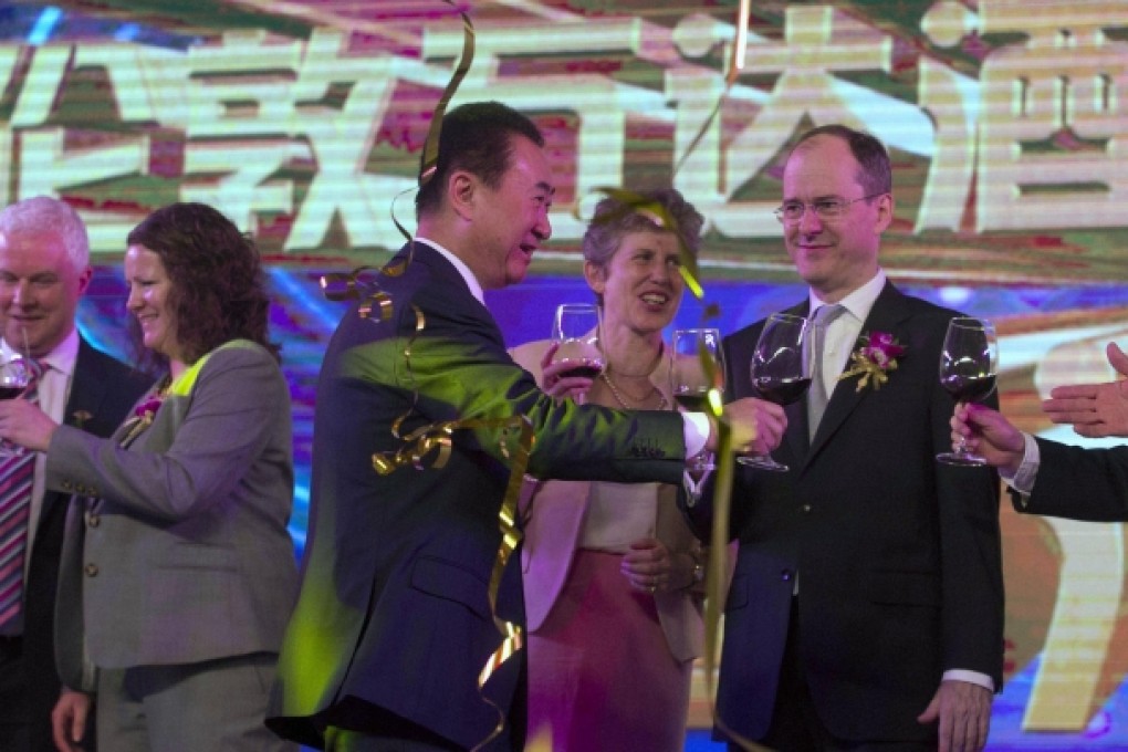 Wanda chairman Wang Jianlin (centre) toasts guests including British ambassador Sebastian Wood (right) in a celebration in Beijing for the Sunseeker acquisition. Photo: AP