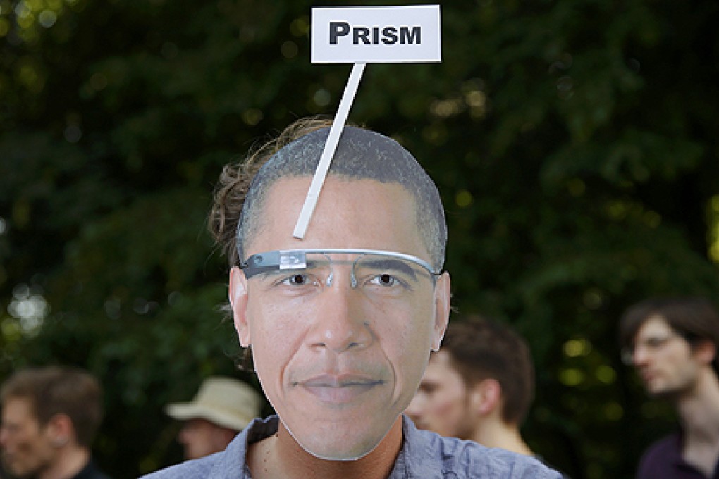 A German protester wears a mask with the portrait of US President Barack Obama sporting Google Glass during a protest in Berlin on Wednesday. Photo: Reuters