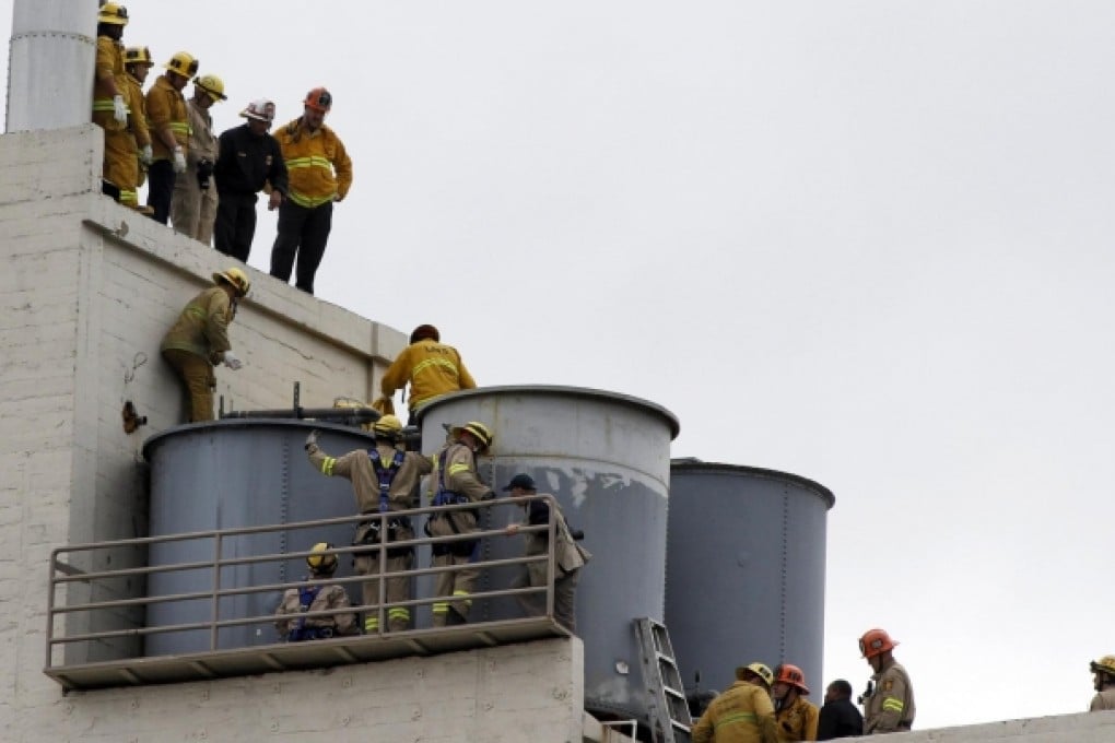 The body of Elisa Lam is removed from a tank on the roof. Photo: Reuters