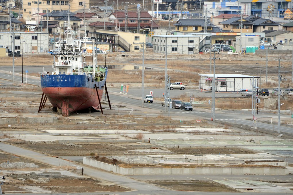 In this February photo, a fishing boat sits in Kesennuma, stranded by the 2011 tsunami. The vessel may be left there as a memorial. Photo: AFP