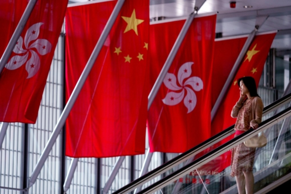 China and Hong Kong flags are hoisted at the HSBC headquarters in Central for the Chinese National Day celebrations. Photo: Martin Chan