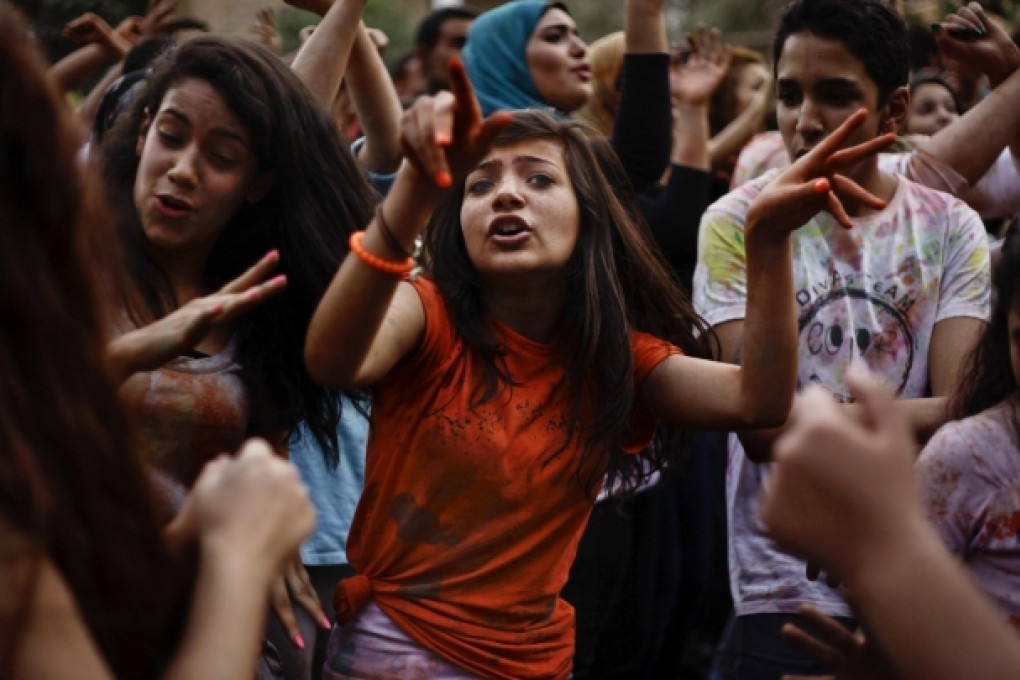 A group of young Egyptians gyrate to the hypnotic rhythms and raspy-voiced songs at a mahraganat concert in Cairo. Photo: AP