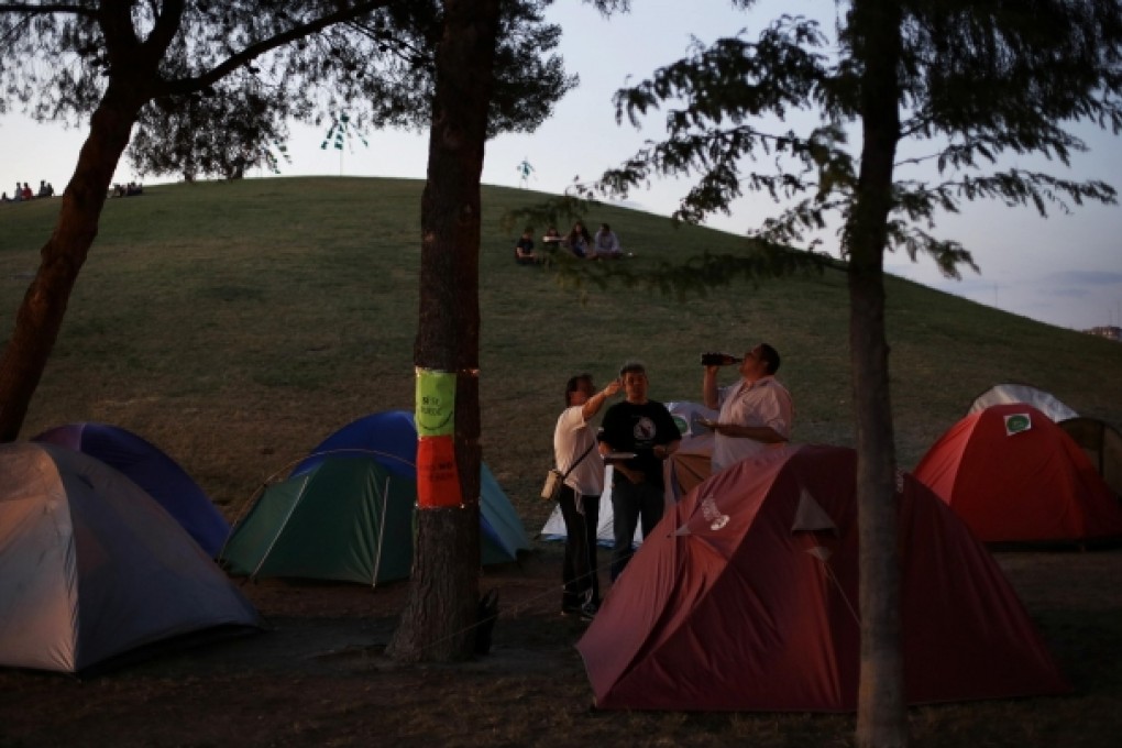 Members of an unemployed assembly group in Madrid eat by their protest camp. Youth unemployment stands at 62.5 per cent in Greece, 56.4 per cent in Spain and more than 40 per cent in Italy and Portugal. Photo: Reuters