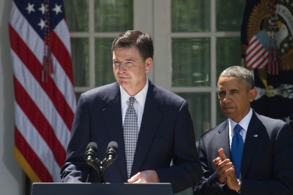 Barack Obama applauds Jim Comey in the Rose Garden after nominating him to become the next director of the FBI. Photo: AFP