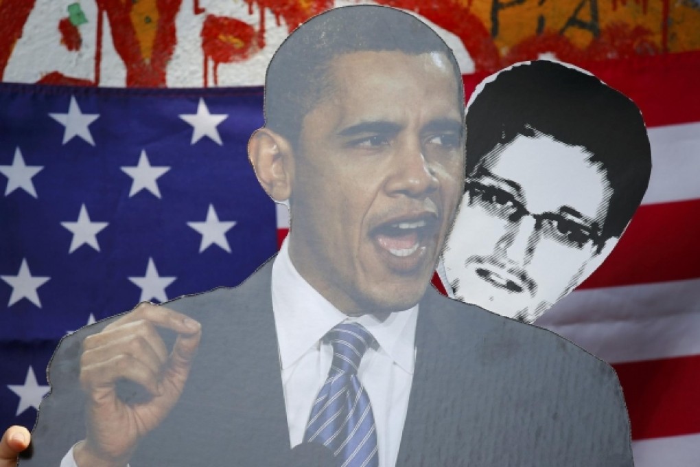 Obama and Snowden placards at a Berlin protest. Photo: Reuters