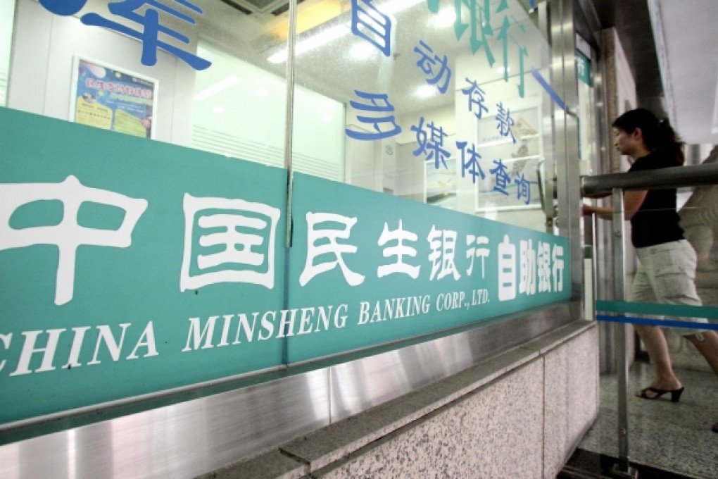 A woman walks into a China Minsheng Banking Corp branch in Shanghai. The bank's net earnings may fall by 3.7 per cent this year, according to Barclays. Photo: Bloomberg