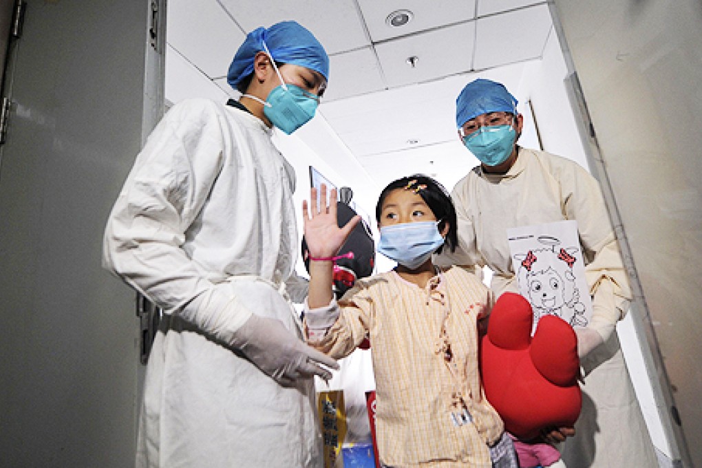 A girl, who was previously infected with the H7N9 bird flu virus, leaves a Beijing hospital in April. Photo: Reuters