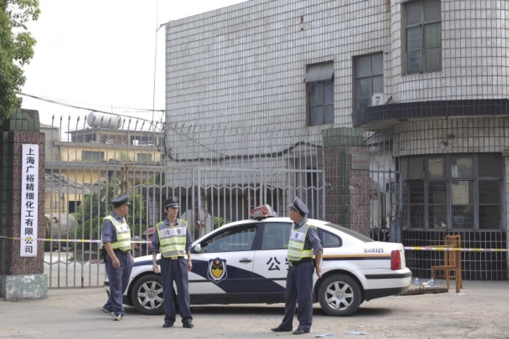 Security officers stand guard at the murder site of Shanghai Guangyu fine chemical company in Baoshan district, Shanghai. Photo: Xinhua