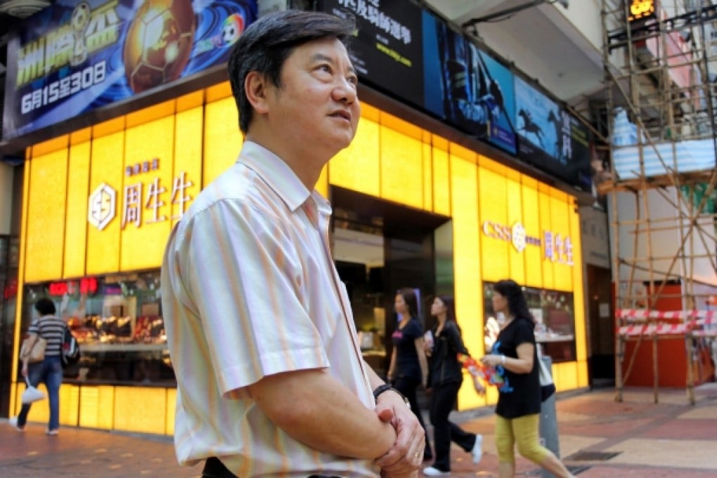 Lai Wing-to in front of his shop on Russell Street, the world's most expensive street. Photo: SCMP