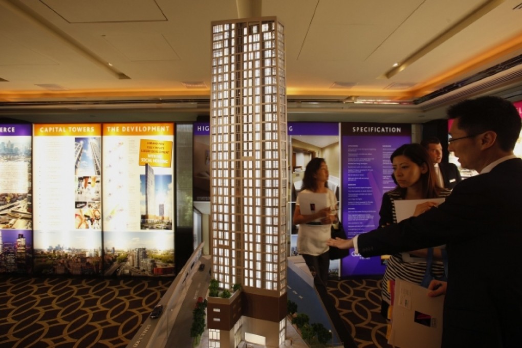 A salesman shows off a luxury development in London to potential buyers in Hong Kong. Photo: Reuters