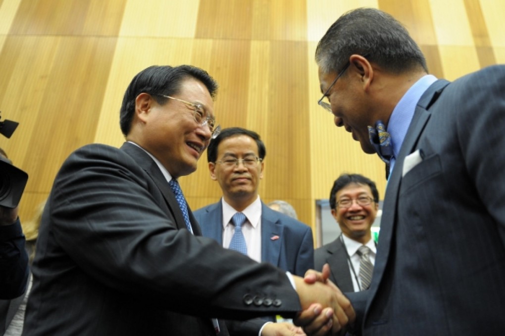 Li Yong (left) is congratulated on his UN appointment after a meeting in Vienna. Photo: Xinhua