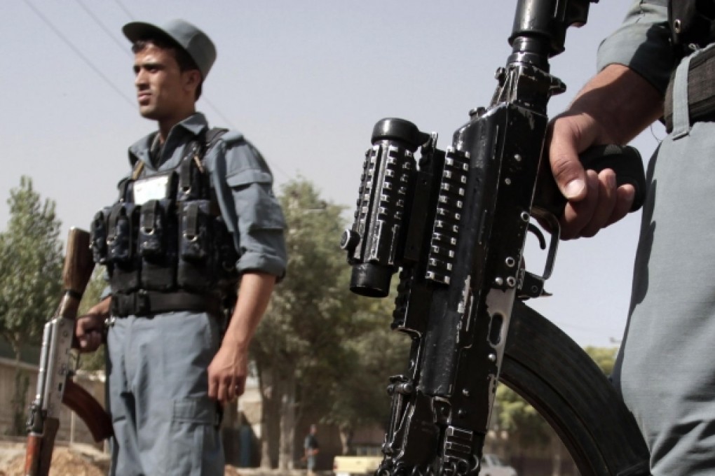 Afghan security forces stand guard near the entrance to the presidential palace in Kabul after a Taliban attack yesterday. Photo: AP