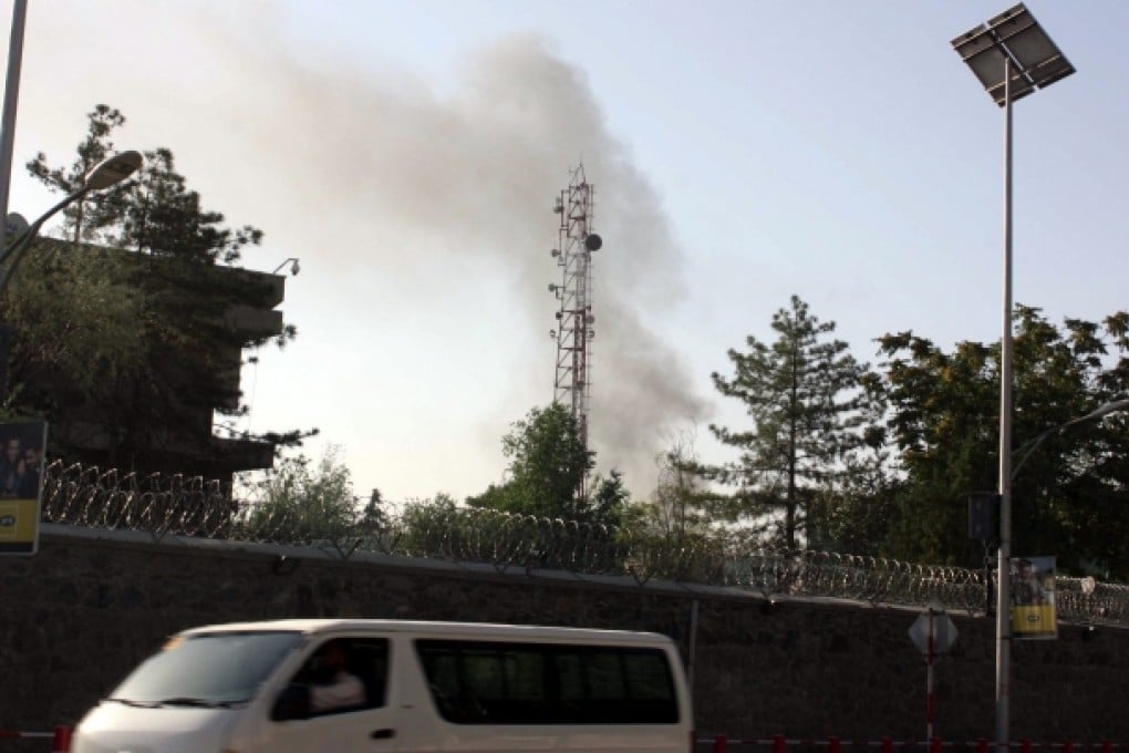 Smoke billows from the scene of gunfight between Taliban militants and Afghan security officials near the Presidential palace in Kabul. Photo: EPA