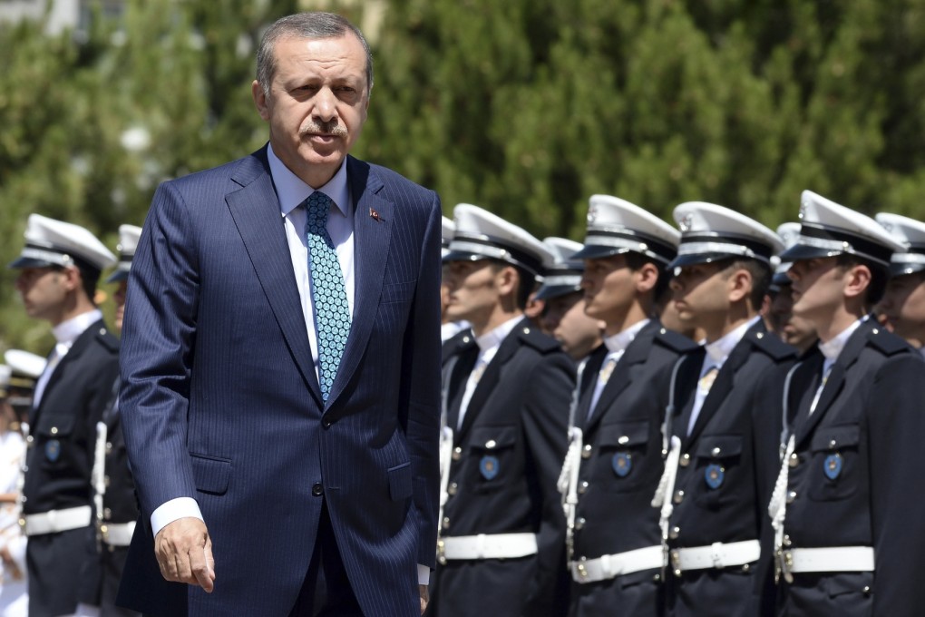 Turkey's Prime Minister Tayyip Erdogan (left). Turkish police have raided homes in the capital, Ankara, detaining people involved in protests against Erdogan's government. Photo: Reuters