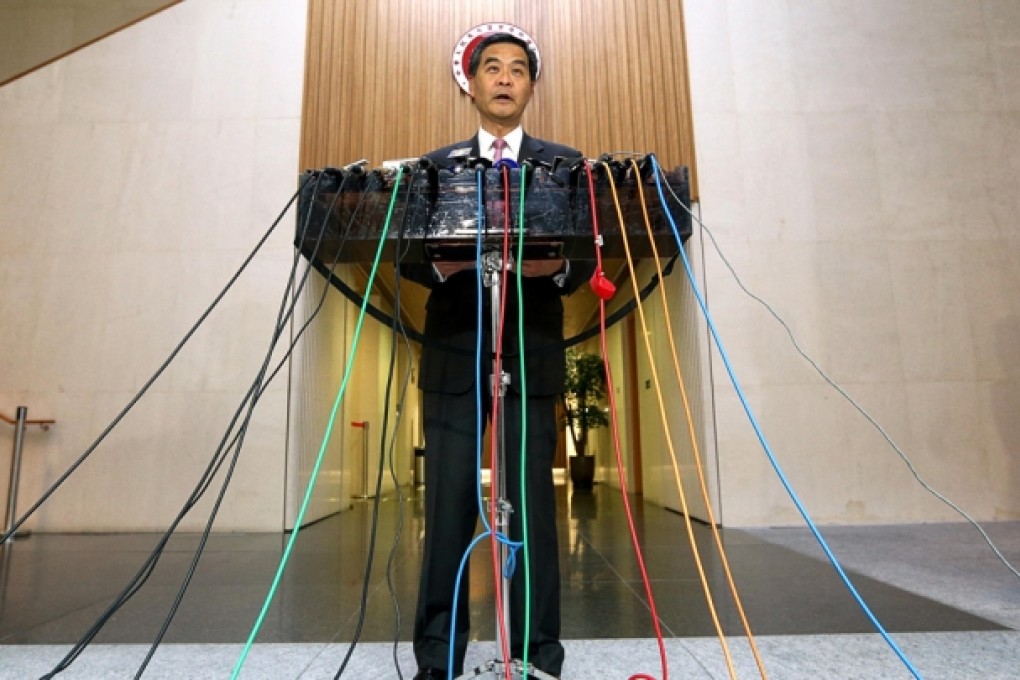 Leung Chun-ying unveils the report at government headquarters summarising his year. Photo: Sam Tsang