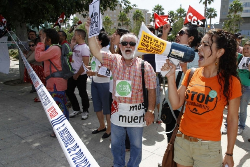 Members of Mortgage Victim's Platform (PAH), a Spanish group, protest outside the annual meeting of Spain's largest nationalised bank Bankia. Photo: Reuters