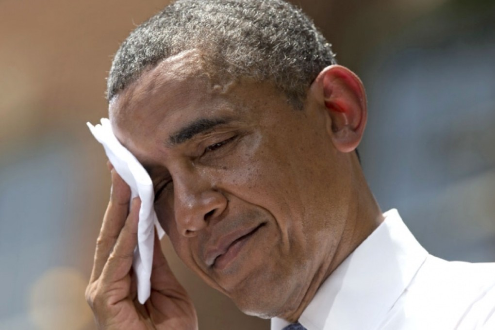 President Barack Obama wipes sweat from his head during a speech on climate change. Photo: AP