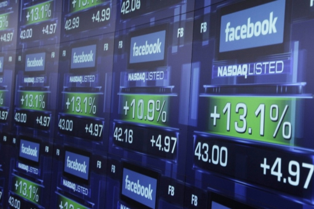 Electronic screens show the price of Facebook shares after they began trading in New York on June 27, 2012. Photo: AP