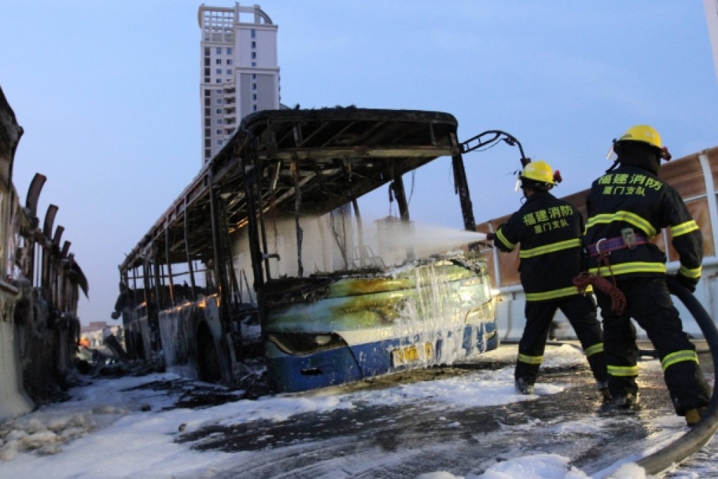 Firefighters try to extinguish the fire on a bus in Xiamen, southeast China's Fujian Province. Photo: Xinhua